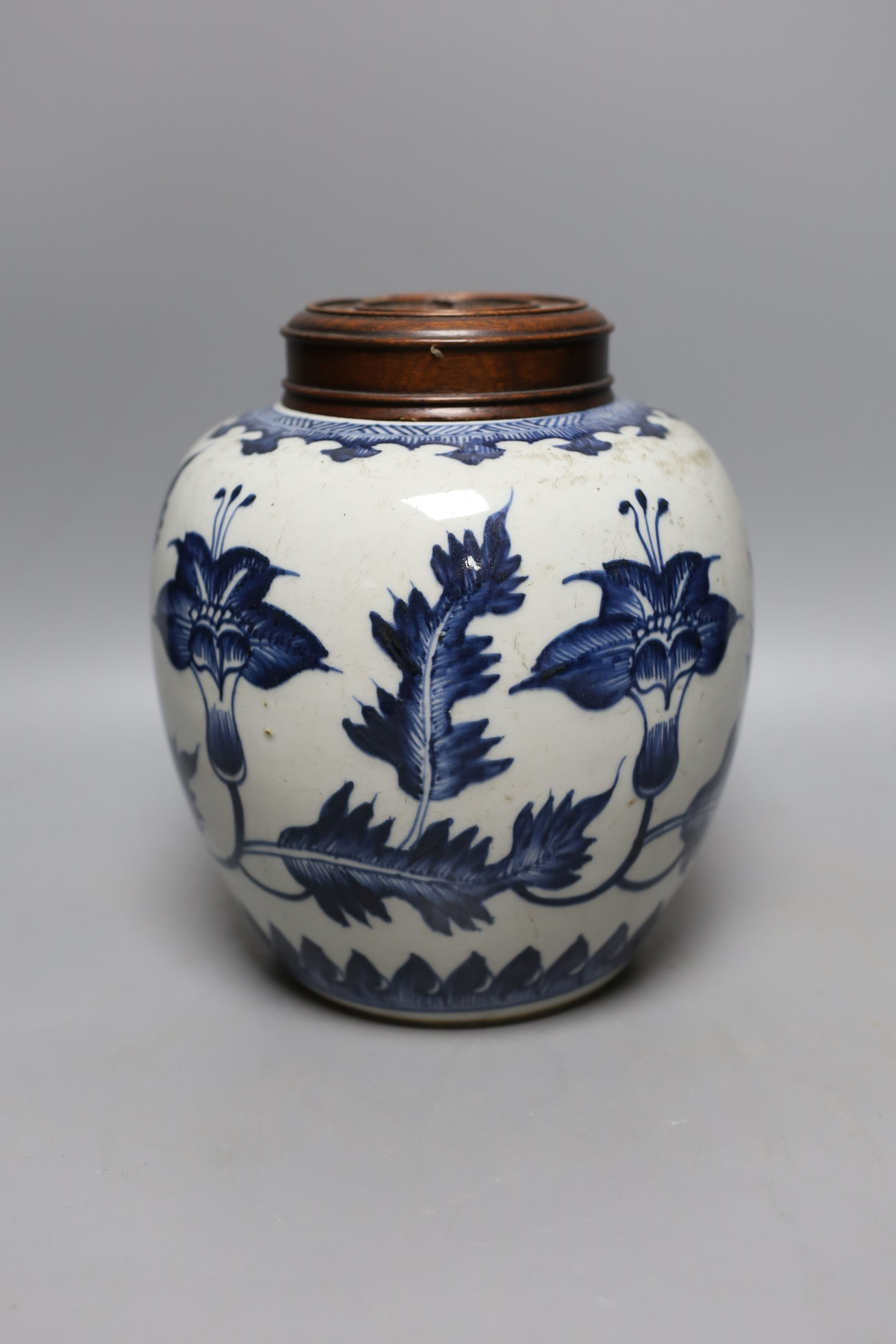 A 18th/19th century Chinese blue and white jar and wood cover - 22cm high